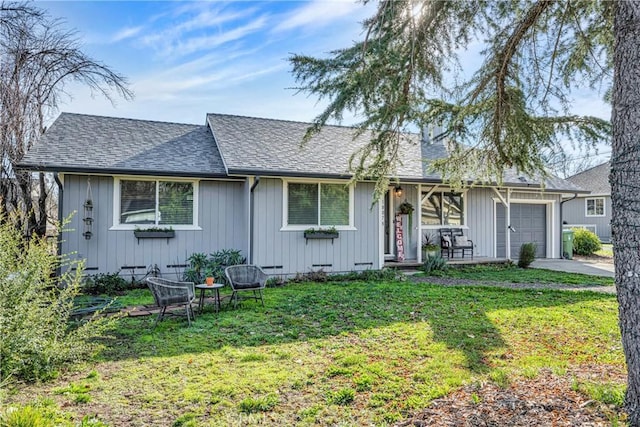 single story home featuring a front yard and a garage