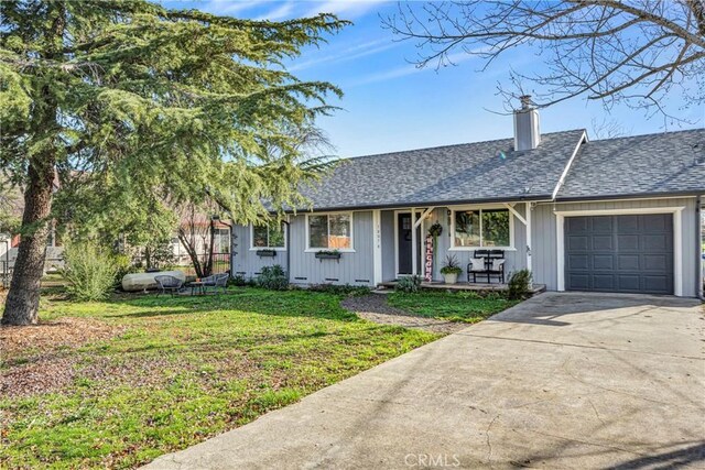 single story home with a front lawn and a garage