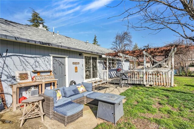 deck featuring a yard, an outdoor living space, and a patio