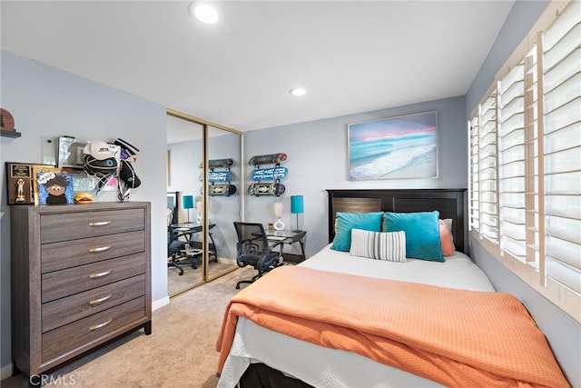 carpeted bedroom with a closet and multiple windows