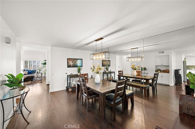 dining space with dark hardwood / wood-style floors