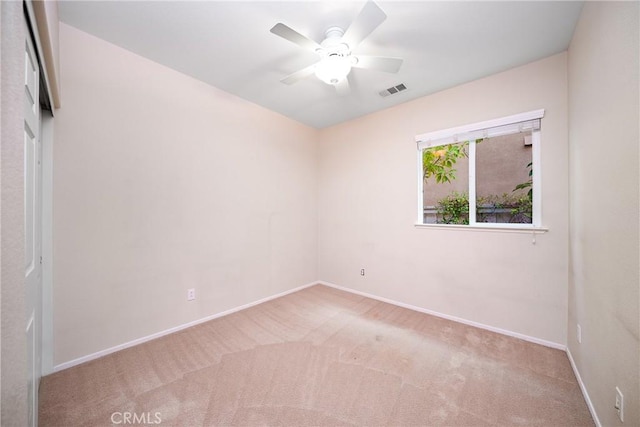 carpeted empty room featuring ceiling fan