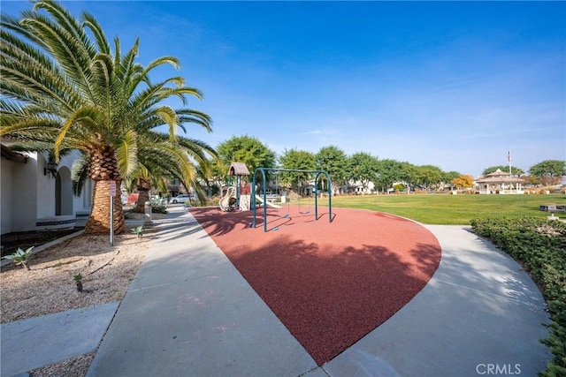 view of home's community with a playground and a lawn