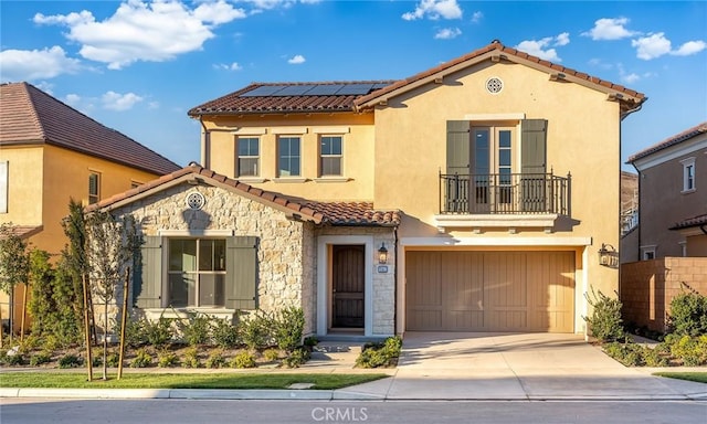 mediterranean / spanish-style house with a balcony, a garage, and solar panels