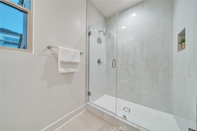 bathroom featuring an enclosed shower and tile patterned flooring