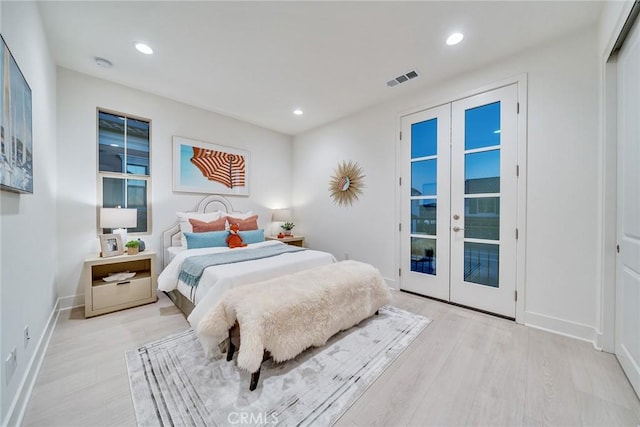 bedroom with light wood-type flooring, access to exterior, and french doors