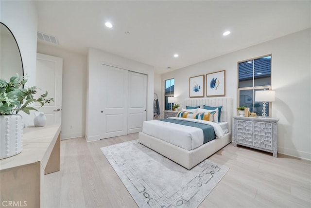 bedroom featuring light wood-type flooring and a closet