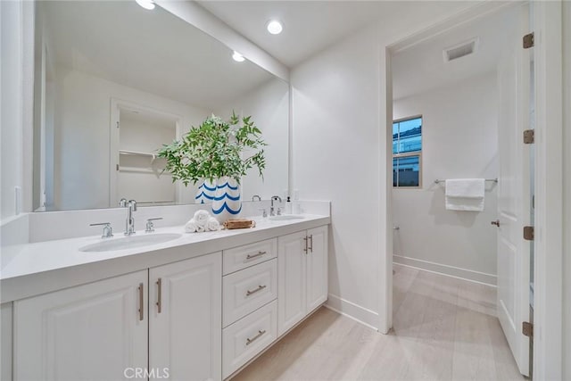 bathroom featuring hardwood / wood-style flooring and vanity