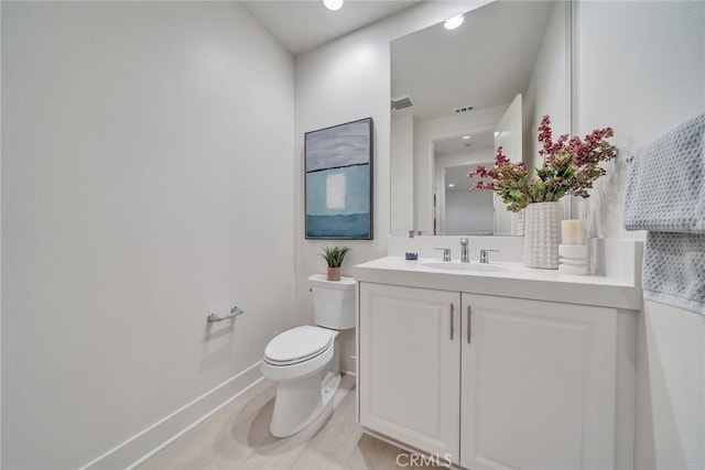 bathroom featuring toilet and vanity