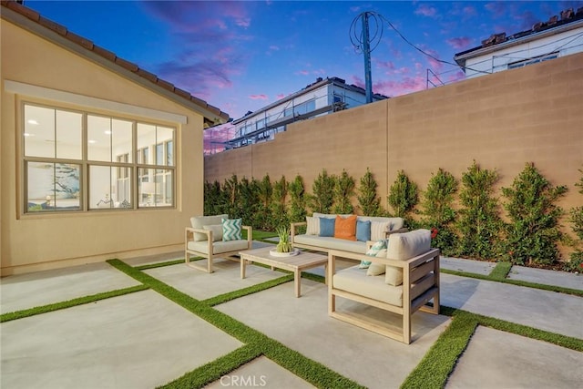 patio terrace at dusk featuring outdoor lounge area