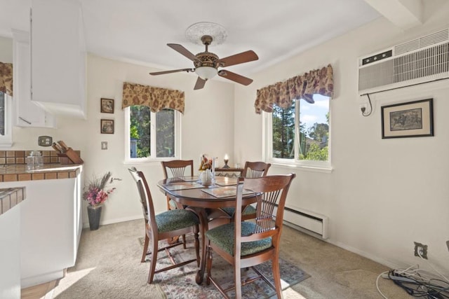 dining room featuring ceiling fan, light carpet, and baseboard heating