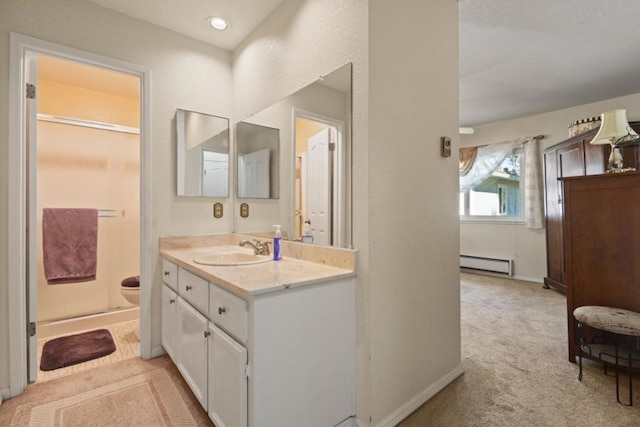 bathroom featuring a baseboard radiator, vanity, and a shower with shower door