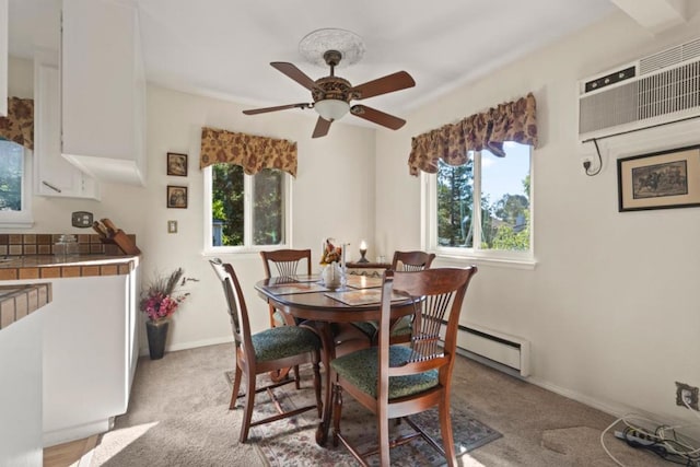 carpeted dining space featuring ceiling fan, an AC wall unit, and a baseboard heating unit