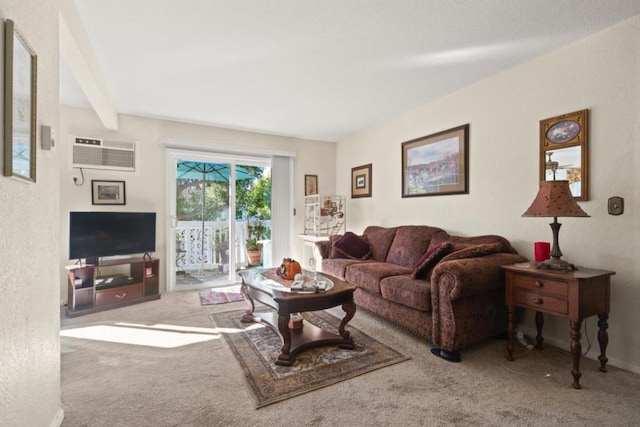 carpeted living room featuring beam ceiling and a wall mounted AC