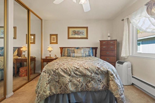 carpeted bedroom featuring baseboard heating and ceiling fan