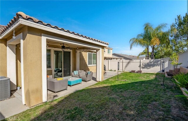 back of property featuring ceiling fan, a patio area, a yard, an outdoor hangout area, and central air condition unit