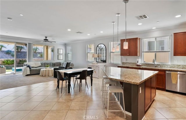 kitchen with dishwasher, a center island, decorative light fixtures, ornamental molding, and ceiling fan