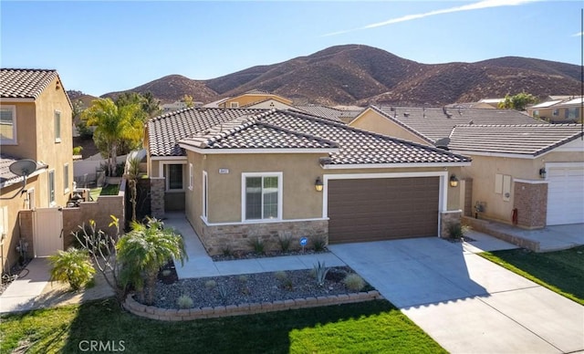 mediterranean / spanish-style house featuring a mountain view and a garage