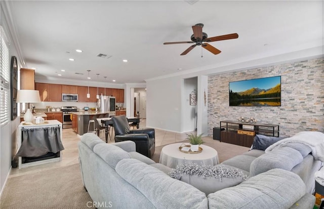 living room with ceiling fan and crown molding