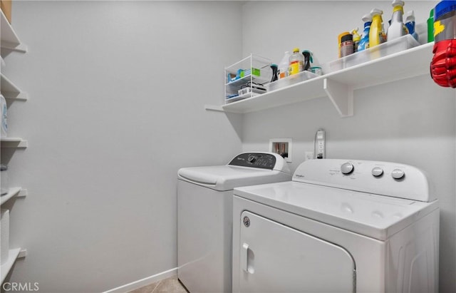 laundry area with light tile patterned floors and independent washer and dryer