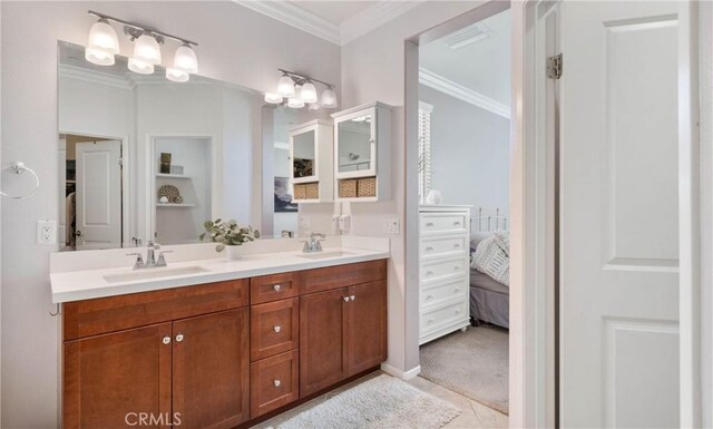 bathroom with tile patterned flooring, ornamental molding, and vanity