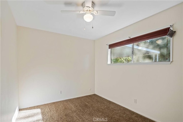 unfurnished room with ceiling fan and carpet