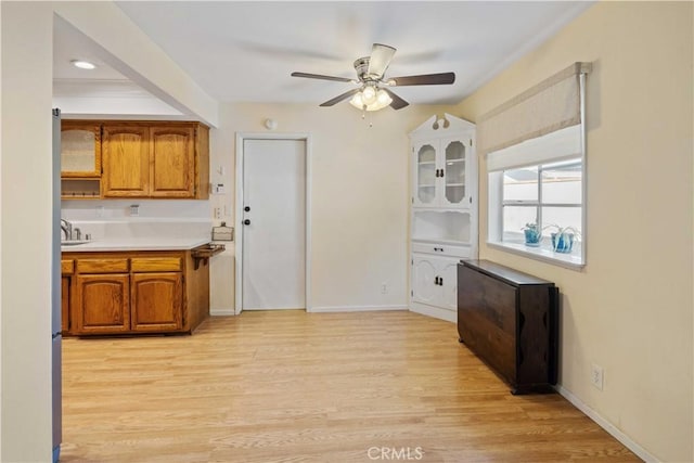 kitchen with ceiling fan and light hardwood / wood-style floors