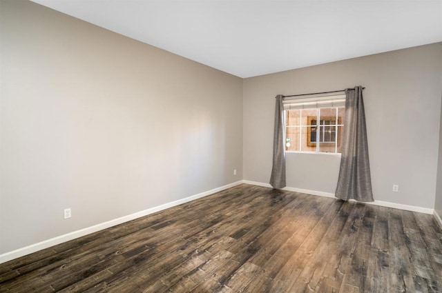 spare room with dark hardwood / wood-style flooring