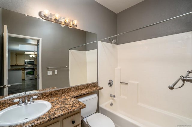 full bathroom featuring toilet, shower / washtub combination, and vanity