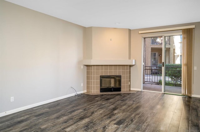 unfurnished living room with dark hardwood / wood-style floors and a fireplace