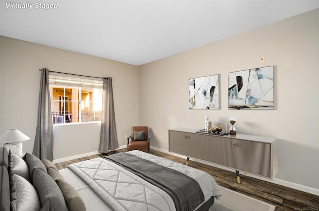 bedroom with dark hardwood / wood-style flooring