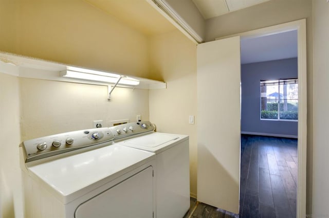 laundry area with dark wood-type flooring and separate washer and dryer