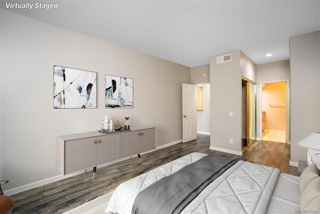 bedroom featuring ensuite bathroom, a closet, and dark hardwood / wood-style floors