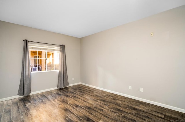 spare room with dark hardwood / wood-style floors