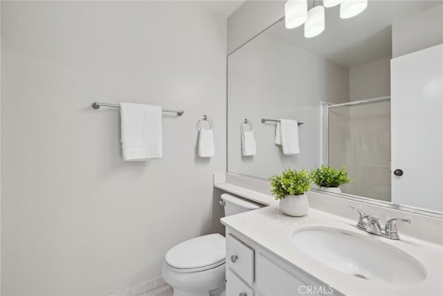 bathroom with toilet, a shower with shower door, and vanity