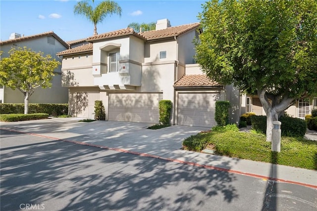 mediterranean / spanish house with a garage