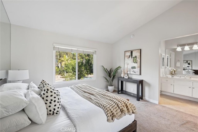 carpeted bedroom with lofted ceiling