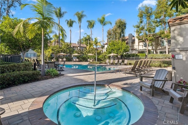 view of pool with a patio area and a community hot tub