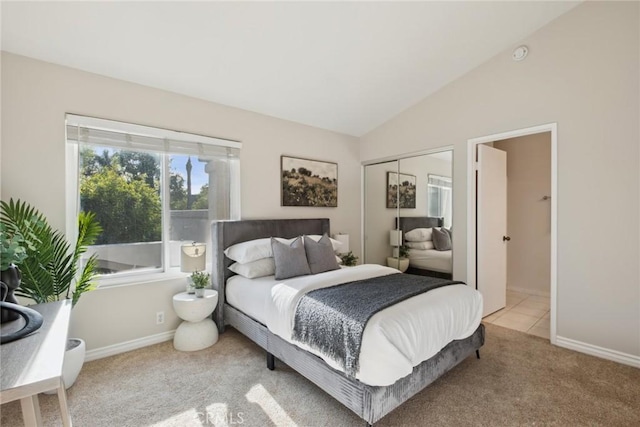 carpeted bedroom with vaulted ceiling and a closet