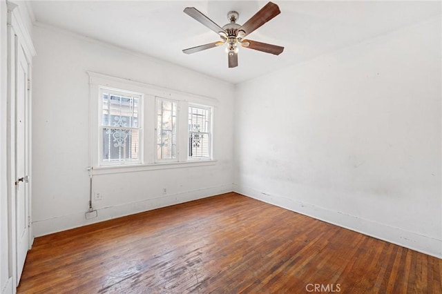 empty room featuring ceiling fan and hardwood / wood-style floors