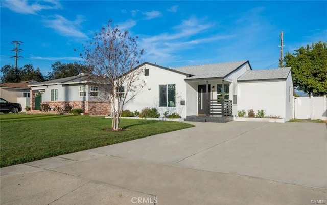 ranch-style home featuring a porch and a front yard