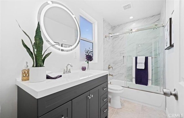 full bathroom featuring combined bath / shower with glass door, vanity, and toilet