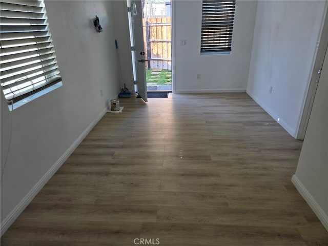 empty room featuring a wealth of natural light and hardwood / wood-style floors