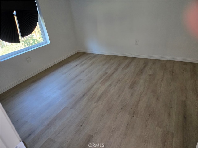 spare room with light hardwood / wood-style floors