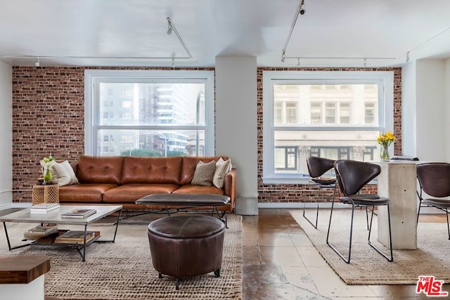 living room with brick wall and track lighting