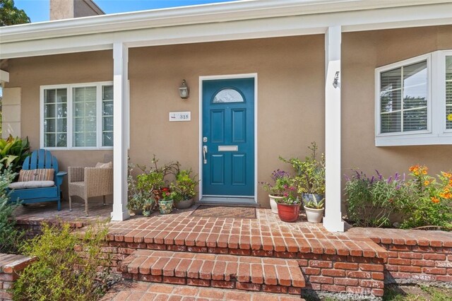 doorway to property featuring a porch