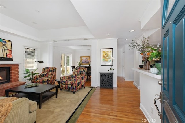 living room with a fireplace and light hardwood / wood-style floors