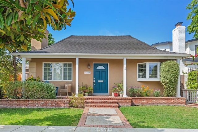 bungalow-style home with a front yard