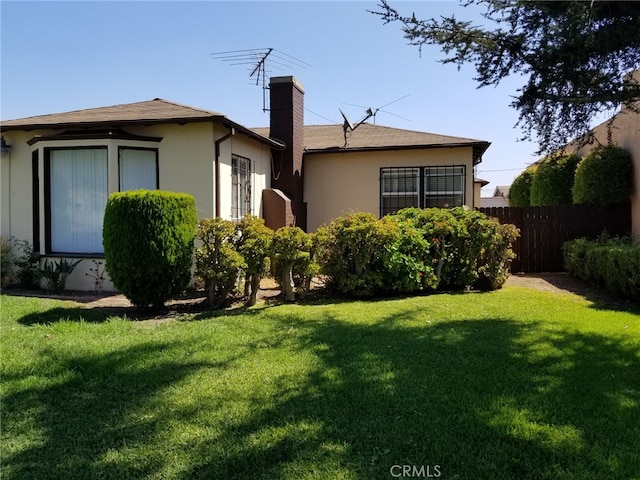 rear view of house featuring a lawn