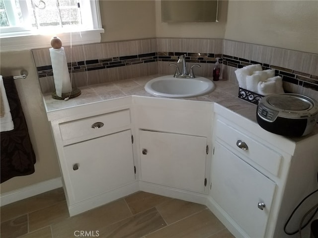 bathroom featuring tile patterned flooring and vanity